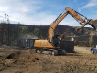 Case excavator on dirt pile