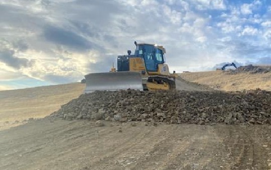 Construction equipment leveling ground for a concrete pour 